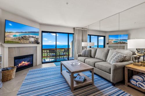 a living room with a couch and a fireplace at Full Ocean View-2 Decks-Heated Pool in Aptos