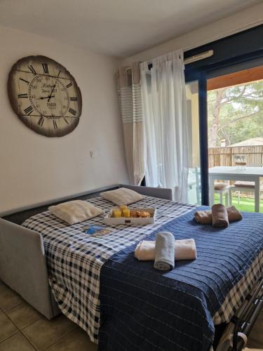a bedroom with a bed with a large clock on the wall at Sanary sur mer, Soleil et douceur III in Sanary-sur-Mer