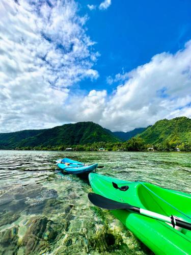 a group of boats on a body of water at Teahupo'o Lodge Tahiti - Fare Terre et Mer - climatisé - canoe et paddle in Teahupoo