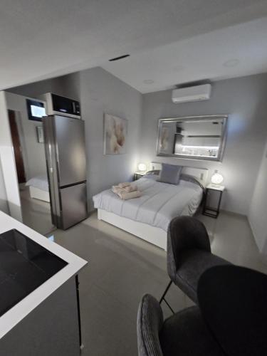 a small bedroom with a bed and a refrigerator at Panoramic Montain in Cabrils