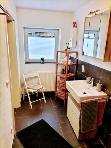 a bathroom with a sink and a mirror at Ferienwohnung Schneider in Münk