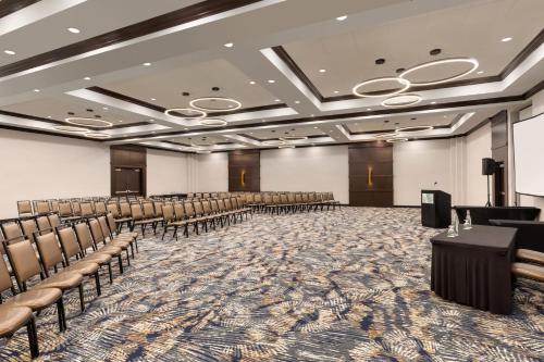 a conference room with chairs and a podium in the middle at Holiday Inn Virginia Beach - Norfolk by IHG in Virginia Beach