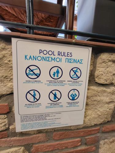 a sign on the side of a brick wall at Blue Home, Luxury Villa with Pool in the City Centre in Larisa