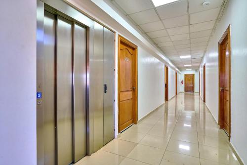 a corridor of an office building with wooden doors at Hotel Libertad at historic main street in Santo Domingo