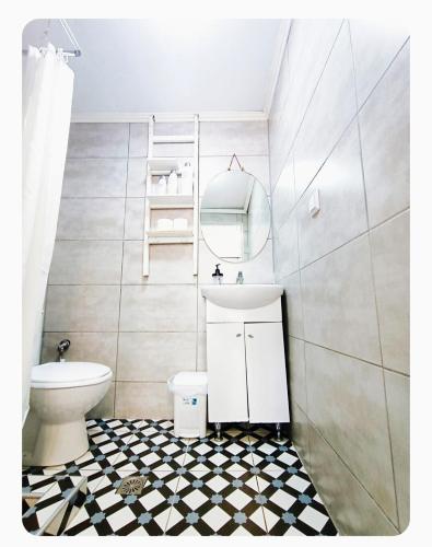 a bathroom with a white toilet and a sink at The SPiTi Project 32 in Kavála