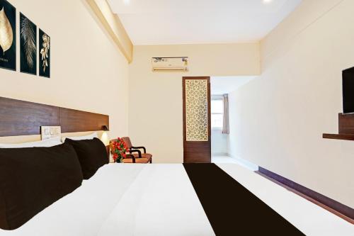 a bedroom with a large bed and a television at Super Collection O Gandhipuram in Coimbatore