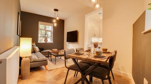 a living room with a table and a couch at The Gate House-Wyndale Living- West Malvern in Great Malvern
