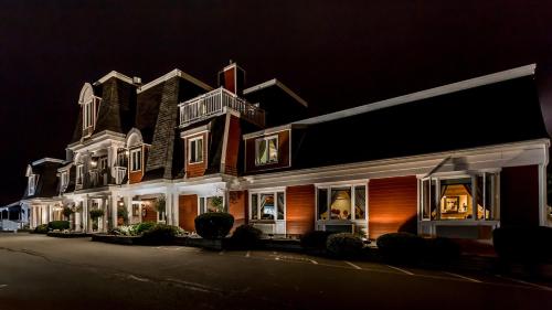 a large building with lights in the night at Inn on the Lake in Fall River