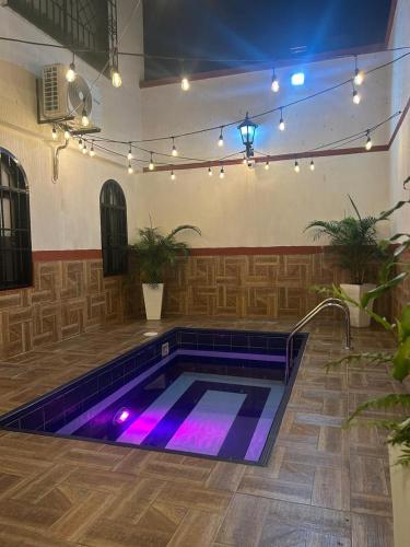 a swimming pool with purple lights in a room at Hotel Terraza in Buga