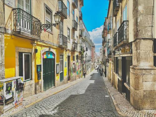 an empty street in an old town with buildings at 4Lisbon Downtown Private Bedroom City View in Lisbon