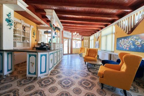 a lobby of a restaurant with orange chairs and a counter at Szent Kristóf Borbirtok in Zamárdi