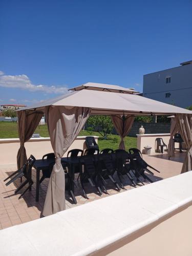 a table and chairs under an umbrella on a patio at Villa Pompei Oasis in Torre Annunziata