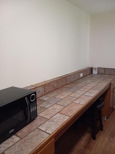 a counter top with a microwave on top of it at Bright and Airy Home in Quiet West Seattle in Seattle