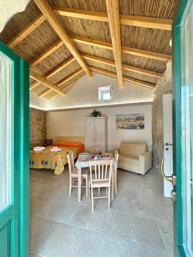 a living room with a table and chairs and a couch at Corte Ludovica in Martano