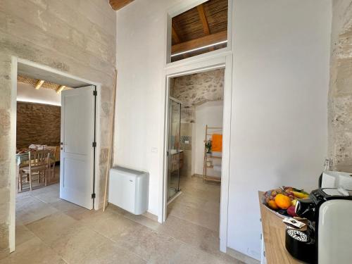 a kitchen with a counter with a bowl of fruit at Corte Ludovica in Martano