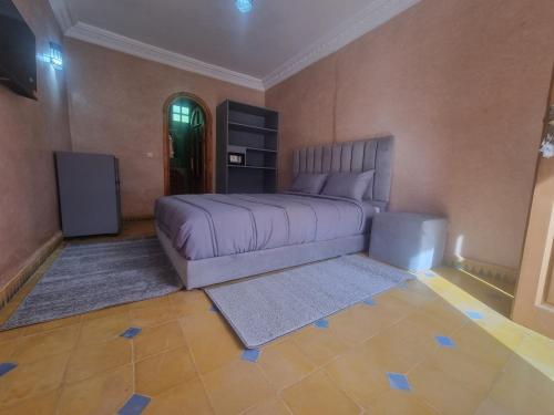 a bedroom with a bed and a television in it at Dar Fatna Marrakech in Marrakech