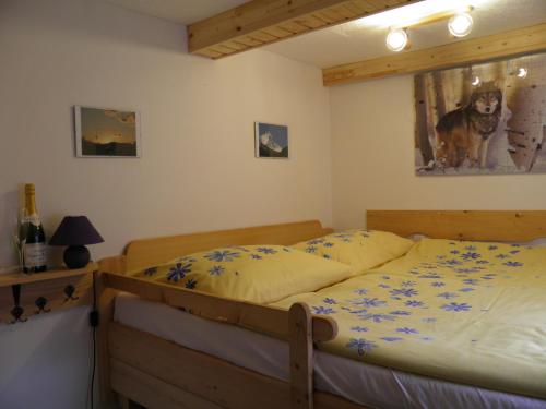 1 dormitorio con 1 cama con una foto de perro en la pared en Bungalov Mladé Buky, en Mladé Buky