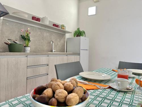 a kitchen with a table with a bowl of food on it at Corte Ludovica in Martano