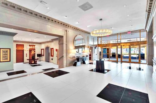 a large room with a lobby with white floors and windows at Central Apartment with Easy Metro Access in Arlington