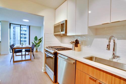 a kitchen with a sink and a stove top oven at Central Apartment with Easy Metro Access in Arlington