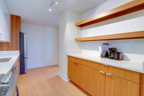 a kitchen with white counter tops and wooden cabinets at Central Apartment with Easy Metro Access in Arlington