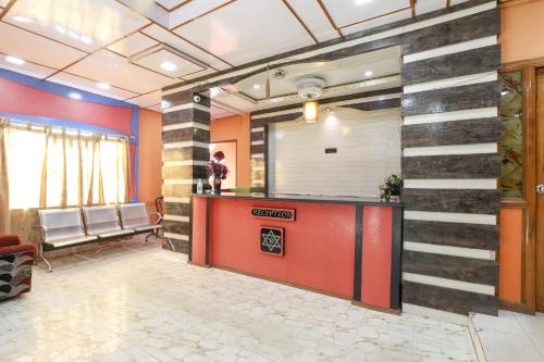an office lobby with a red and black wall at SPOT ON Hotel River View in Guwahati
