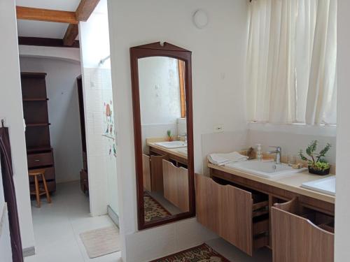 a bathroom with a large mirror and a sink at Hotel Villa Paz in Villa de Leyva
