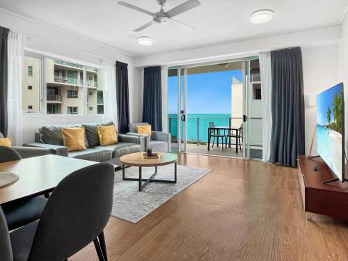 a living room with a view of the ocean at '10-A' Coral Sea Apartment - Pool & Ocean Views in Cairns