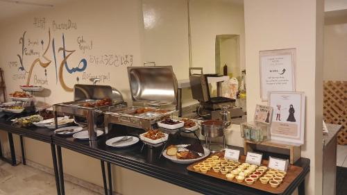a buffet of food on a table in a restaurant at Layaali Amman Hotel in Amman