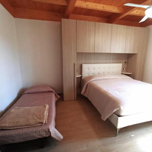 a bedroom with a white bed and a cabinet at Agriturismo La tana della volpe in Alberese