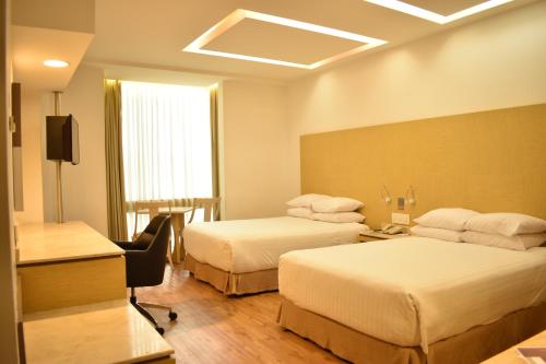 Ein Bett oder Betten in einem Zimmer der Unterkunft Ramada by Wyndham Mexico City Santa Fe