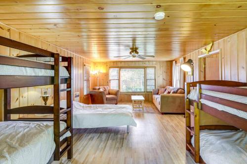 a room with bunk beds and a living room at Lakefront Minnesota Escape with Fire Pit and Boat Dock in Emily