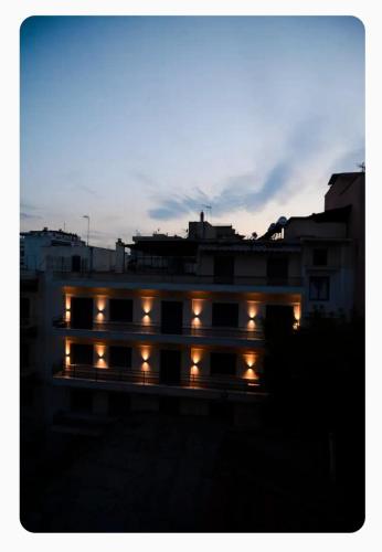 a building lit up at night with lights at The SPiTi Project 23 in Kavála