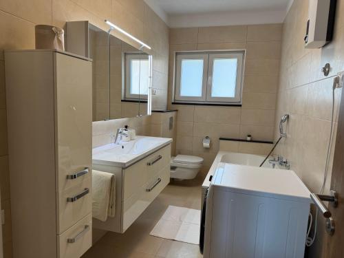 a bathroom with a sink and a toilet and a mirror at Apartment Marino 2 in Duće