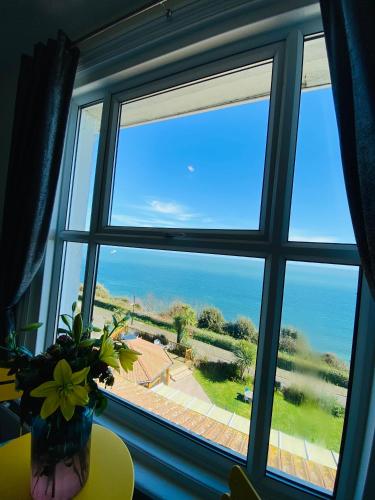 a window with a vase of flowers on a table at Villa Mentone Hotel in Shanklin