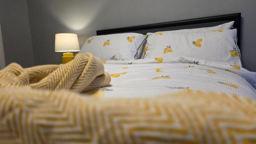 a bedroom with a bed with a white comforter at The Ansi8 in Livingston