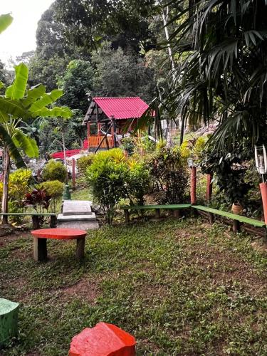 a park with a bench and a gazebo at Finca Peñitas in Boquerón de Capira