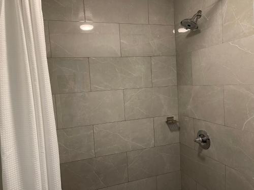 a bathroom with a shower with a shower curtain at Motel 6-Troy, OH in Troy