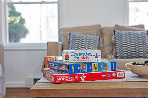 a stack of books on a table in a living room at Home in Bushkill Saw Creek Poconos area in Saw Creek