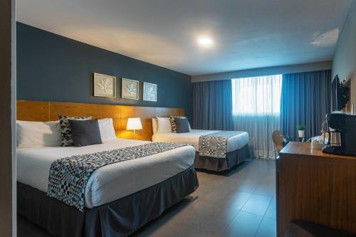 Postel nebo postele na pokoji v ubytování Hotel Aladino