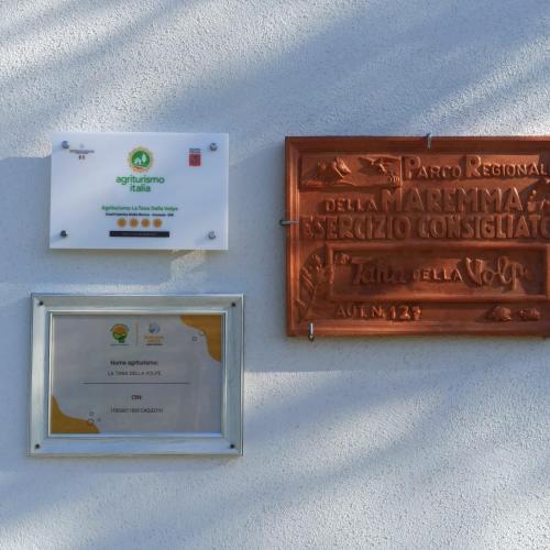 two boxes on a wall with a sign on it at Agriturismo La tana della volpe in Alberese