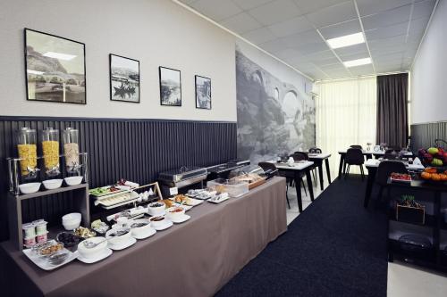 a buffet line with plates of food in a restaurant at Hotel Dirista in Shkodër