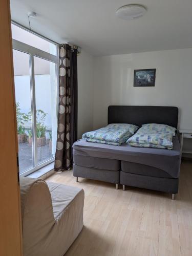 a bedroom with a bed and a large window at Ferienwohnung J10, Playmobil Funpark Zirndorf Nürnberg in Zirndorf
