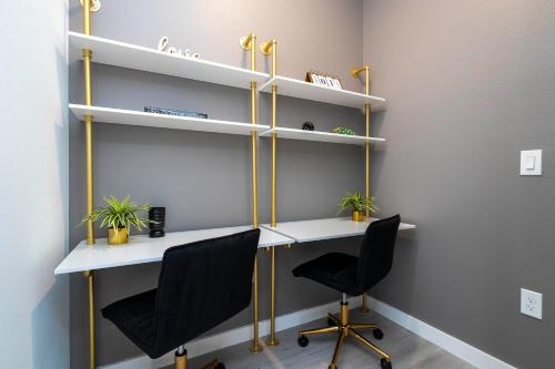 an office with two chairs and a desk with shelves at Luxury 3 Bed Home up to 8 guests- The Hub - 3236 TT in Orlando