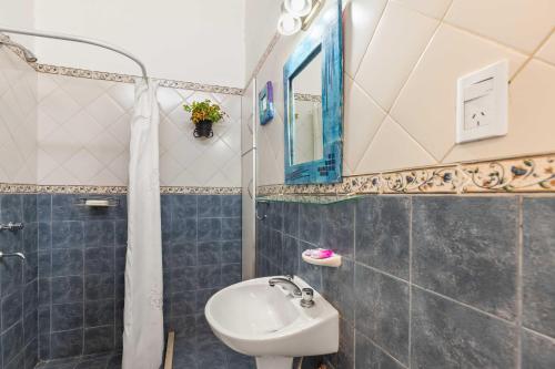 a bathroom with a sink and a toilet and a mirror at El Puerto - Cerca de todo in Cordoba