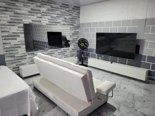 a white room with a fireplace and a white bench at Studio apartment - 4 pax salomia in Cali