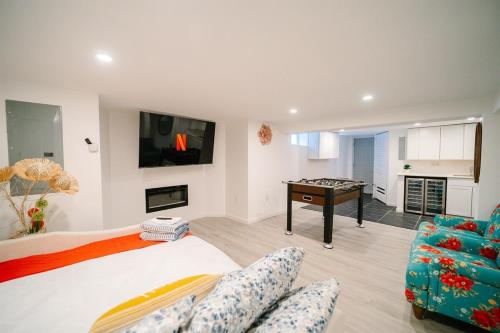 a bedroom with a bed and a couch and a table at Modern 5BR DC Home Free Parking Steps from Metro Family-Friendly in Washington, D.C.