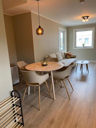 a living room with a table and a couch at Leilighet i sentrum in Sokndal