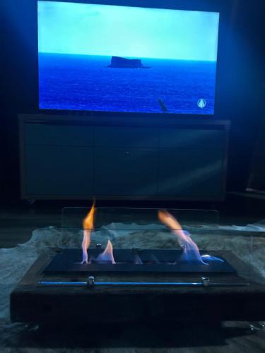 two people standing in a pool in front of a tv at Chalé Pôr do Sol in Contenda