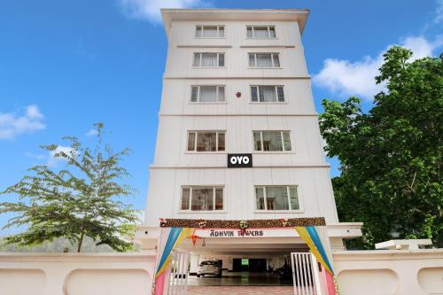 a white building with a sign on it at Hotel O RD CONVENTIONS in Visakhapatnam